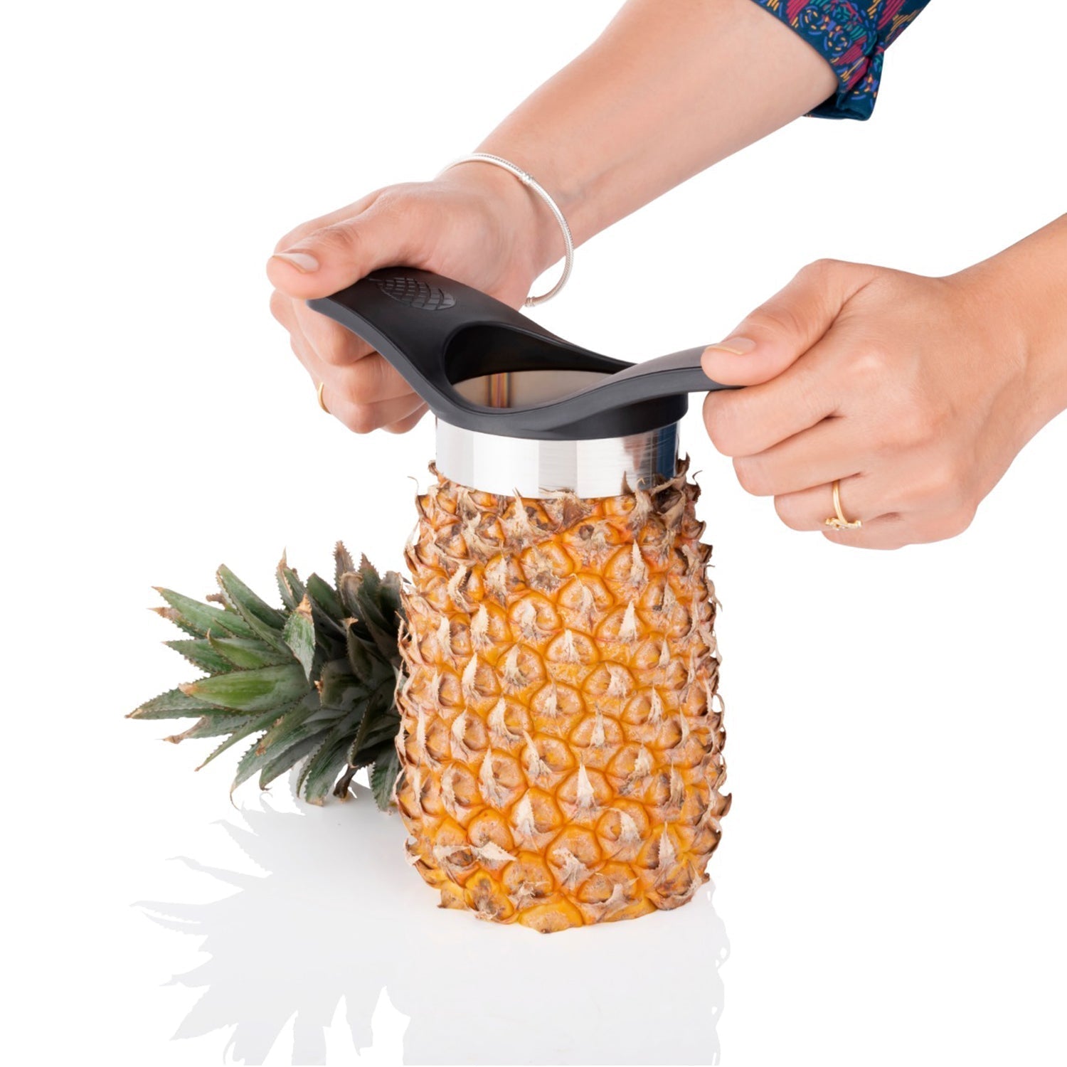 Pineapple slicing tool for household and kitchen purposes.