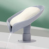 Self-draining soap holder in leaf shape for bathroom or kitchen.