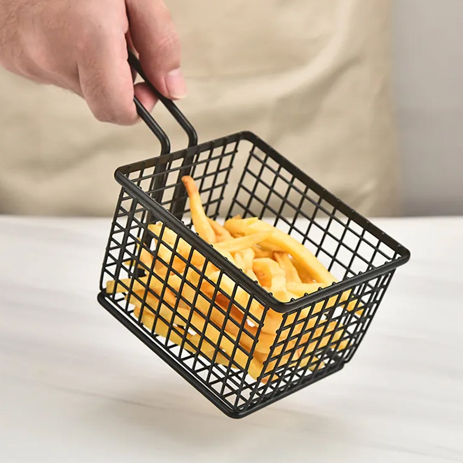 Stainless steel frying basket for snacks and fries.