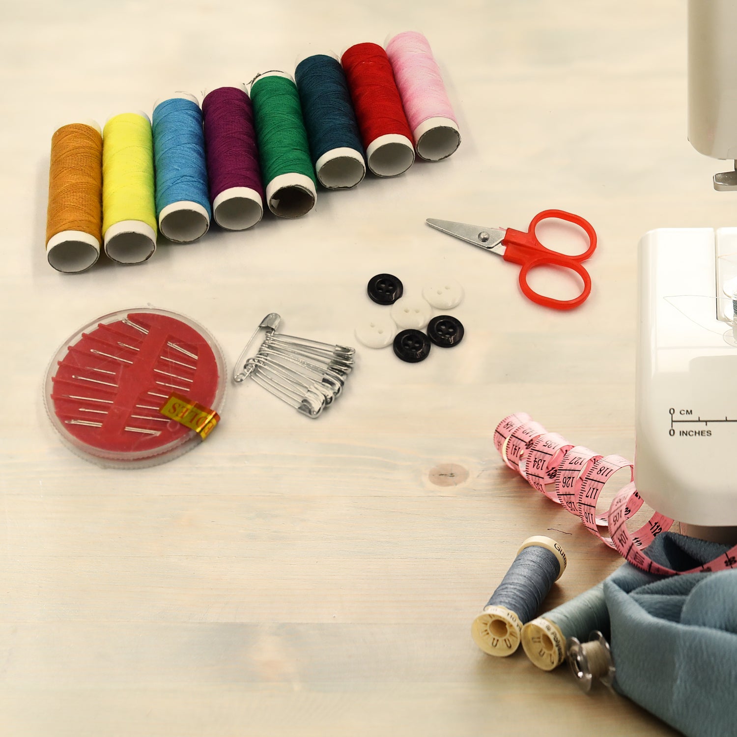 Portable travel sewing kit with double layers, including colorful needles and threads.