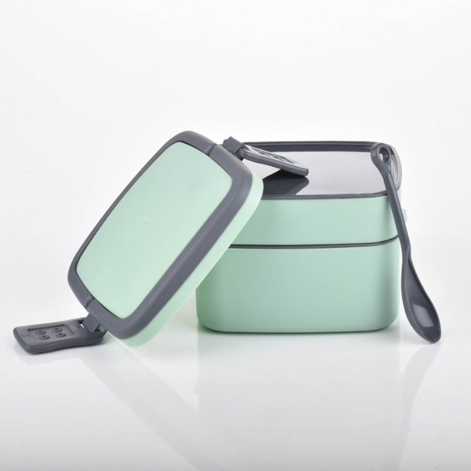 Stackable green lunch box with spoon for everyday use