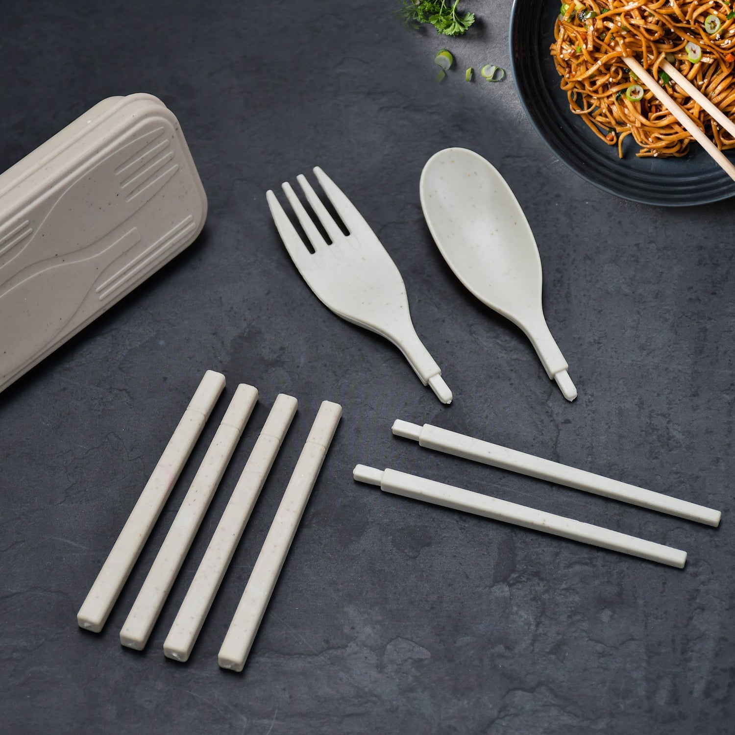 Portable travel cutlery set with spoon, fork, and chopsticks.