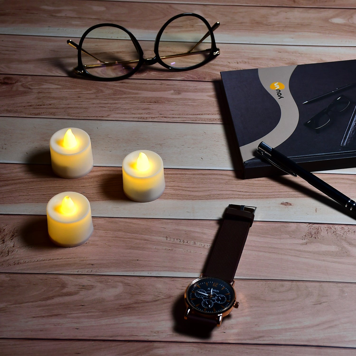 Display of yellow LED tealight candles in white containers.