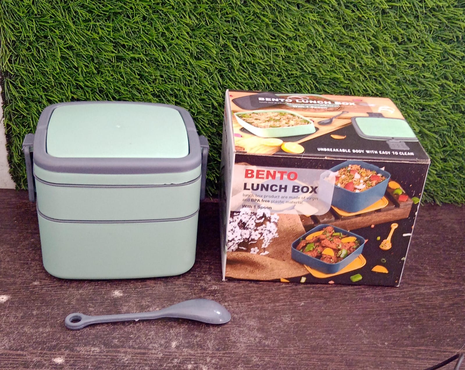 Portable green lunch box with handle and spoon for travel