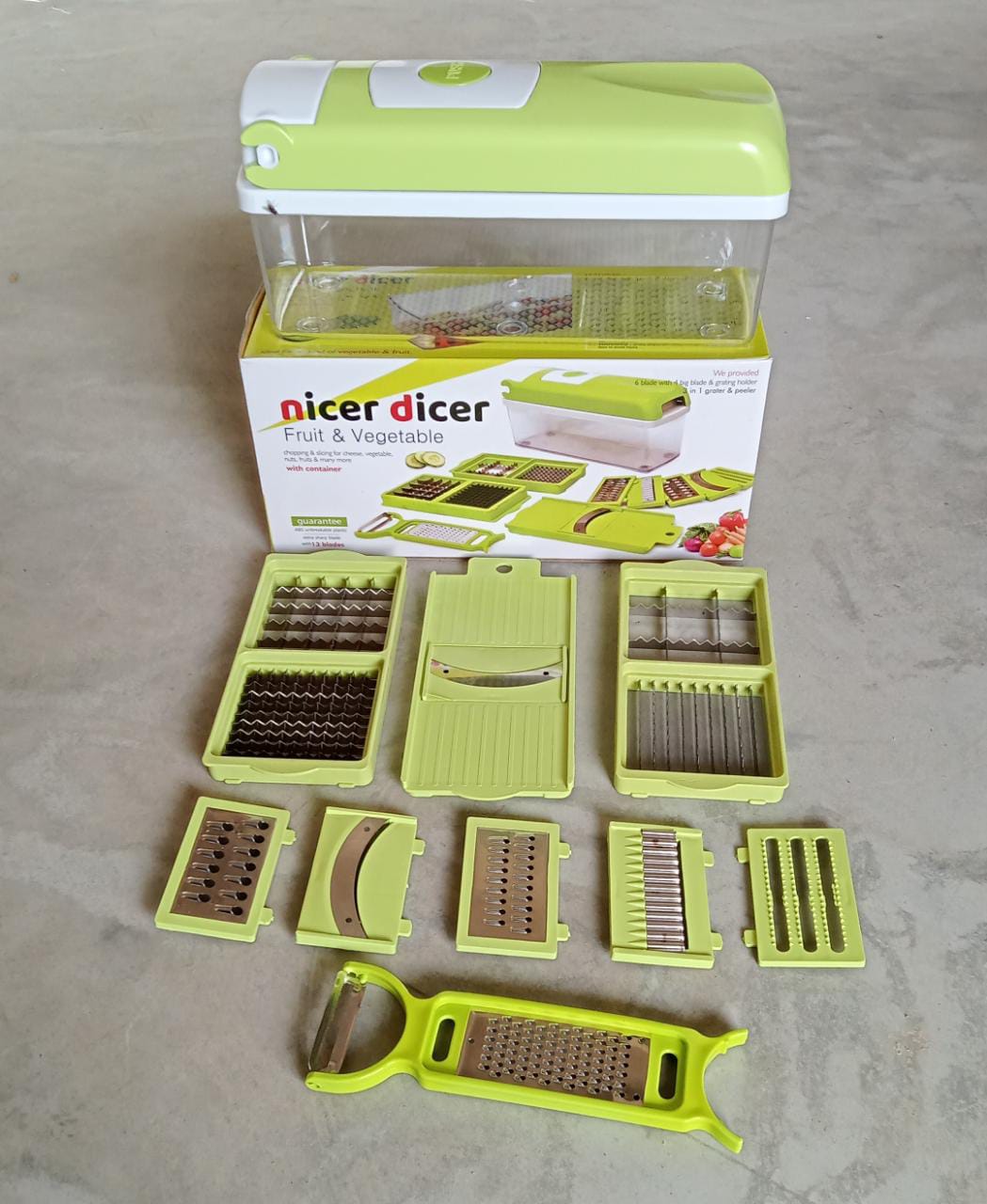 Plastic 13-in-1 grater and slicer with various tools for kitchen use